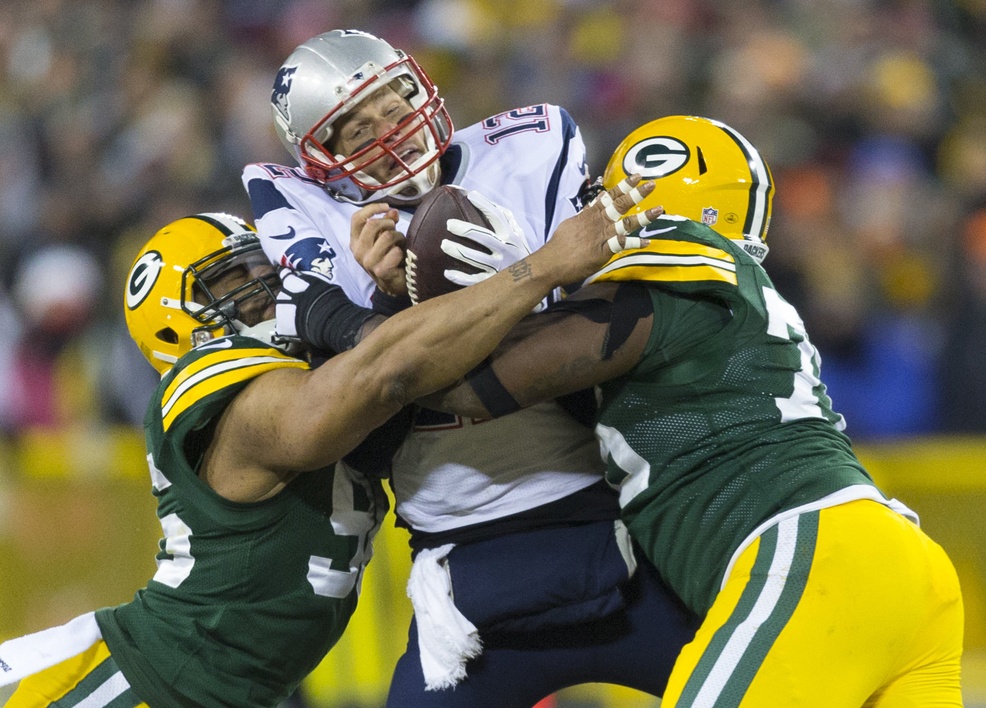 Packers defenders Mike Neal and Mike Daniels sack Patriots quarterback Tom Brady by Jeff Hanisch—USA TODAY Sports.
